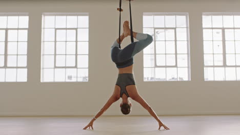 healthy-aerial-yoga-woman-practicing-hanging-upside-down-using-hammock-enjoying-fitness-lifestyle-exercising-in-studio-training-meditation-at-sunrise