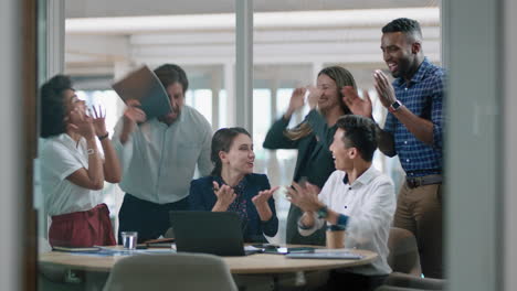group-of-business-people-celebrating-success-watching-laptop-screen-happy-colleagues-applause-enjoying-successful-corporate-victory-achievement-in-modern-office-4k