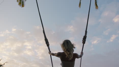 slow-motion-woman-swinging-over-jungle-at-sunrise-travel-girl-enjoying-exotic-vacation-on-swing-in-tropical-rainforest-holiday-lifestyle-freedom-4k