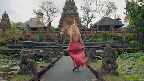 Mujer-Feliz-Bailando-En-El-Templo-Saraswati-Celebrando-Viajes-Disfrutando-De-La-Cultura-De-Bali-Indonesia-4k