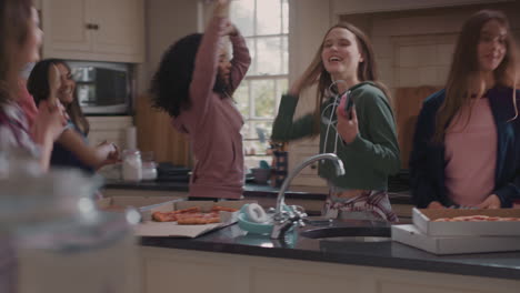 happy-group-of-teenage-girls-dancing-in-kitchen-eating-pizza-having-fun-celebrating-together-enjoying-hanging-out-together-on-party-weekend