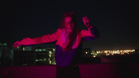 happy-woman-dancing-on-rooftop-at-night-celebrating-enjoying-silly-dance-having-fun-crazy-dancer-girl-in-city-with-red-light