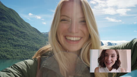 Mujer-Viajera-Feliz-Chateando-Por-Video-Con-Su-Mejor-Amiga-Lanzando-Un-Beso-Compartiendo-Vacaciones-En-Noruega-Divirtiéndose-Mostrando-El-Lago-Y-La-Naturaleza