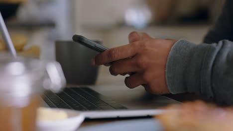 close-up-hands-using-laptop-computer-working-at-home-in-kitchen-typing-email-checking-messages-on-smartphone-enjoying-modern-wireless-communication-technology