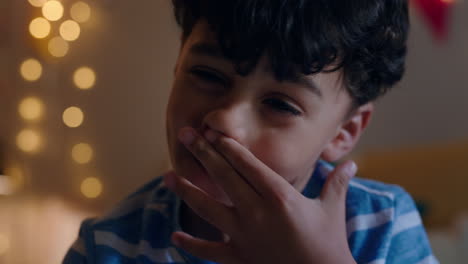 portrait-cute-mixed-race-boy-looking-at-camera-wiping-nose-child-at-home-with-allergy