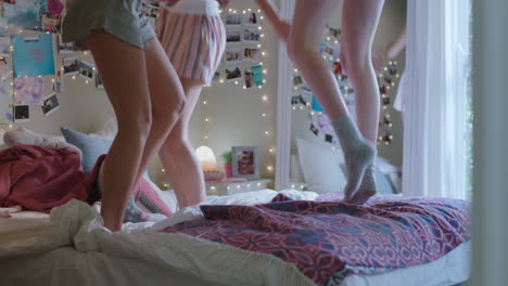 happy-teenage-girls-jumping-on-bed-at-home-best-friends-celebrating-together-enjoying-vacation-weekend