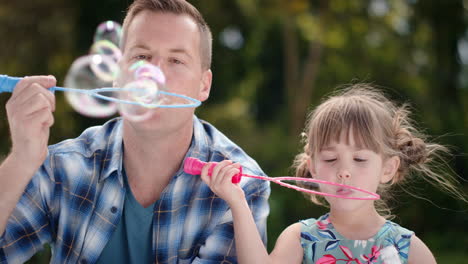 father-and-daughter-blowing-soap-bubbles-together-in-sunny-park-happy-little-girl-having-fun-dad-playing-with-child-playfully-enjoying-summer-4k