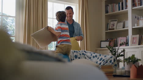 happy-father-having-pillow-fight-with-little-boy-at-home-playfully-enjoying-fun-game-with-dad-4k