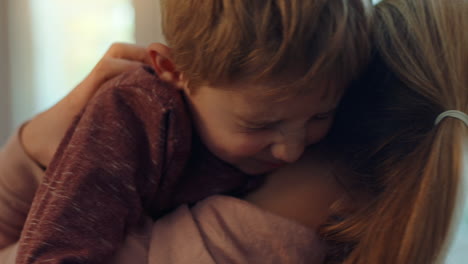 happy-little-boy-hugging-mother-enjoying-loving-mom-embracing-son-at-home-4k-footage