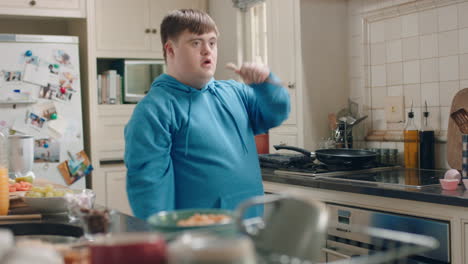 happy-teenage-boy-with-down-syndrome-dancing-in-kitchen-having-fun-celebrating-funny-dance-enjoying-weekend-at-home