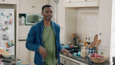 happy-african-american-man-dancing-in-kitchen-having-fun-dance-celebration-enjoying-weekend-at-home