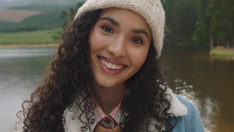 portrait-beautiful-mixed-race-woman-smiling-looking-happy-wearing-beanie-enjoying-cold-winter-outdoors-in-nature-by-lake-real-people-4k