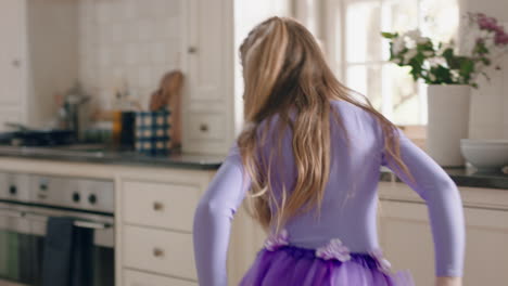 happy-ballerina-girl-dancing-in-kitchen-having-fun-practicing-ballet-dance-moves-wearing-purple-tutu-at-home