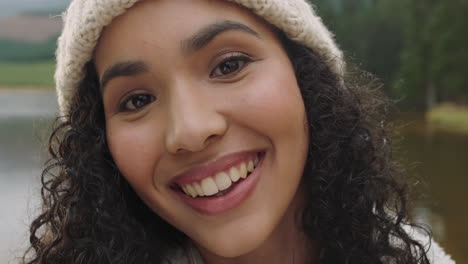 close-up-portrait-beautiful-mixed-race-woman-smiling-looking-happy-wearing-beanie-enjoying-cold-winter-outdoors-in-nature-by-lake-real-people-4k