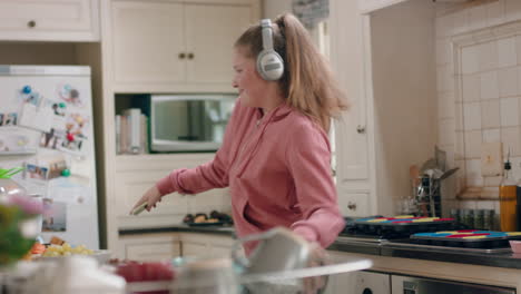 happy-teenage-girl-dancing-in-kitchen-having-fun-celebrating-weekend-performing-funny-dance-moves-listening-to-music-wearing-headphones