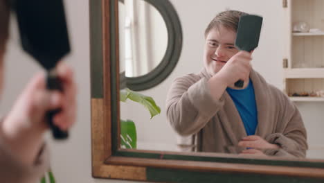 funny-teenage-boy-with-down-syndrome-dancing-in-bathroom-having-fun-brushing-hair-enjoying-morning-routine-getting-ready-wearing-bathrobe