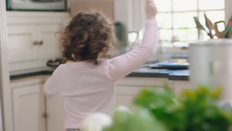 happy-little-girl-dancing-in-kitchen-having-fun-waving-maginc-wand-playing-pretend-doing-funny-dance-moves-enjoying-weekend-at-home