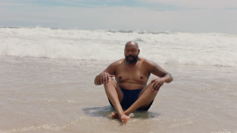 Lustiger-Afroamerikanischer-Mann-Sitzt-Am-Strand-Mit-Plätschernden-Wellen-Und-Hat-Spaß-An-Einem-Warmen-Sommertag-Und-Genießt-Den-Sommerurlaub-4k