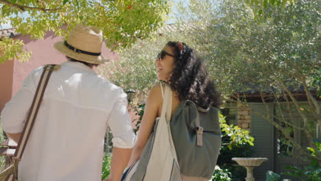 travel-couple-arriving-at-hotel-villa-with-friends-looking-at-beautiful-country-house-excited-for-holiday-tourists-enjoying-summer-vacation-together-4k-footage