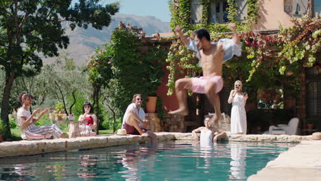 funny-man-jumping-in-swimming-pool-splashing-friends-on-holiday-at-beautiful-villa-people-relaxing-on-warm-summer-day-tourists-enjoying-mediterranean-vacation-4k