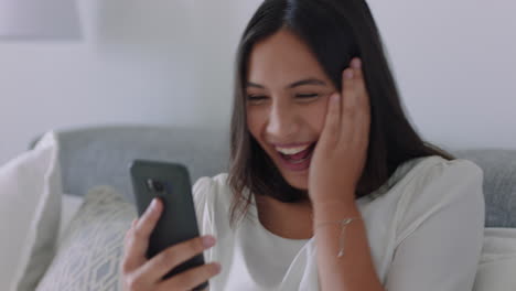 beautiful-mixed-race-woman-having-video-chat-using-smartphone-looking-surprised-enjoying-good-news-chatting-on-mobile-phone-relaxing-at-home