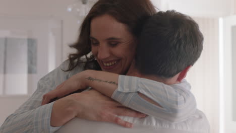 happy-couple-hugging-excited-woman-embracing-boyfriend-sharing-good-news-enjoying-romantic-relationship-at-home