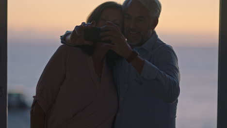 happy-old-couple-taking-photo-using-smartphone-hugging-enjoying-successful-retirement-sharing-vacation-on-social-media-at-sunset