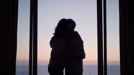 silhouette-happy-old-couple-dancing-in-hotel-room-celebrating-anniversary-retirement-on-vacation-enjoying-successful-marriage-having-fun-dance-at-sunset