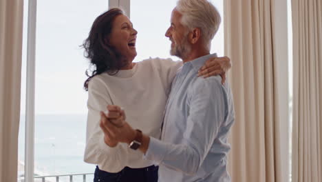 Glückliches-Reifes-Paar,-Das-Zu-Hause-Tanzt-Und-Eine-Erfolgreiche-Beziehung-Genießt-Und-Spaß-Daran-Hat,-Den-Jahrestag-Des-Ruhestands-Zu-Feiern