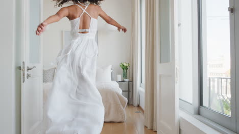 happy-woman-jumping-on-bed-having-fun-laughing-enjoying-independent-lifestyle-celebrating-freedom