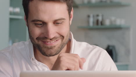 attractive-young-man-using-laptop-computer-browsing-online-enjoying-successful-lifestyle-relaxing-at-home-looking-out-window-planning-ahead