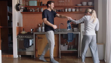happy-young-couple-dancing-in-kitchen-enjoying-funny-dance-together-having-fun-celebrating-relationship-on-weekend-at-home
