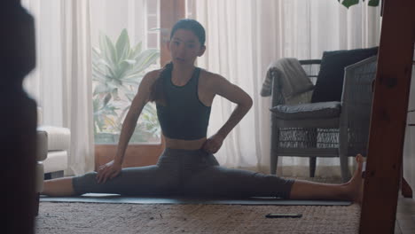 healthy-asian-woman-exercising-at-home-practicing-stretching-in-living-room-enjoying-morning-fitness-workout