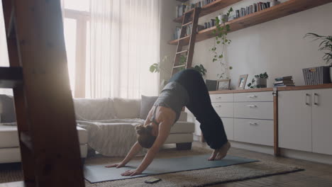 healthy-yoga-woman-exercising-at-home-practicing-three-legged-downward-facing-dog-pose-in-living-room-enjoying-morning-fitness-workout