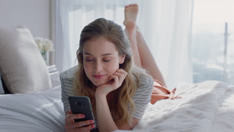 beautiful-woman-using-smartphone-texting-browsing-social-media-messages-enjoying-mobile-phone-communication-lying-on-bed-at-home