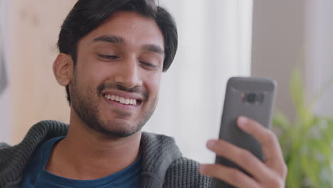 happy-indian-man-having-video-chat-using-smartphone-waving-at-baby-blowing-kiss-enjoying-chatting-on-mobile-phone-at-home