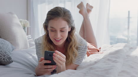 beautiful-woman-using-smartphone-texting-browsing-social-media-messages-enjoying-mobile-phone-communication-lying-on-bed-at-home