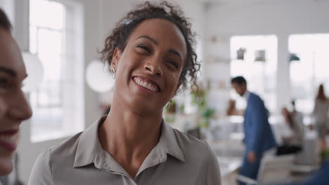 mixed-race-business-woman-chatting-with-clients-smiling-enjoying-developing-corporate-partnership-discussing-project-in-modern-office-workspace