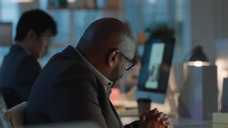 african-american-businessman-working-late-in-offce-using-computer-brainstorming-browsing-online-research-planning-deadline-for-corporate-project