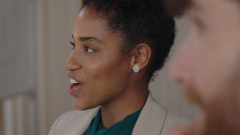 happy-african-american-business-woman-chatting-to-colleague-laughing-having-fun-in-office-meeting-enjoying-connection