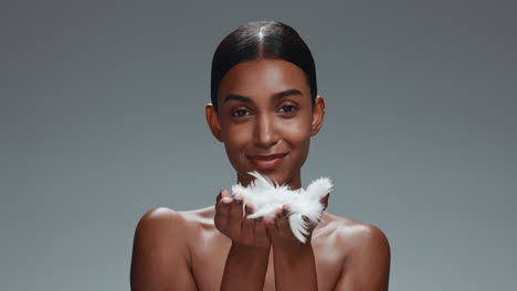 Happy-woman,-skincare-and-blowing-feather