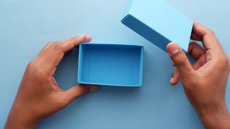Top-view-of-person-open-a-empty-small-gift-box-,