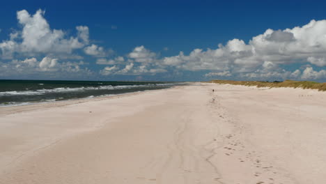 Slider-of-beautiful-coastal-landscape.-Long-white-sand-beach-and-waves-washing-coast.-Summer-vacation-location.-Denmark