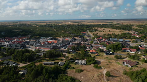 Slide-and-pan-shot-of-centre-of-small-town.-Oksby-and-flat-landscape-from-height.-Summer-vacation-destination.-Denmark