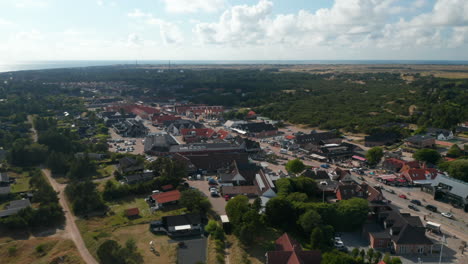Aerial-panoramic-footage-of-small-town-in-flat-countryside.-Buildings-along-main-street-in-Oksby.-Summer-vacation-destination.-Denmark