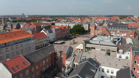 Aerial-view-over-the-famous-Torvet-square-with-brick-buildings-and-the-statue-of-Christian-IX.-Slow-camera-rotation-over-Torvet-square-neighborhood-in-Esbjerg,-Denmark,-with-the-International-House