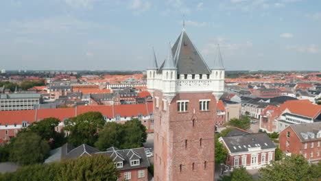 Close-up-aerial-view-slow-camera-rotation-around-the-roof-of-Water-Tower-of-Esbjerg,-Denmark.-Esbjerg-Water-Tower-is-an-iconic-water-tower-at-the-top-of-a-cliff