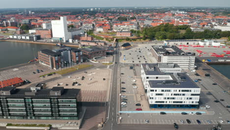 Birds-eye-of-Esbjerg-harbor,-one-of-the-largest-of-the-North-Sea.-Flight-forward-revealing-the-stunning-skyline-and-panorama-of-the-city