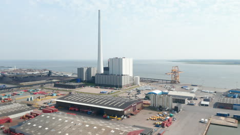 Aerial-view-slow-rotation-over-the-city-of-Esbjerg-with-his-harbor-and-the-Steelcon-chimney-of-the-coal-and-oil-fueled-power-station.-This-chimney-is-the-tallest-in-all-Scandinavia