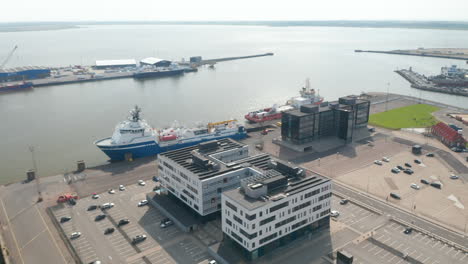 Aerial-view-of-Esbjerg-harbor,-one-of-the-largest-harbour-of-the-North-Sea.-High-angle-view-of-the-cargo-ship-waiting-at-the-dock-for-export-and-import-business-and-logistics